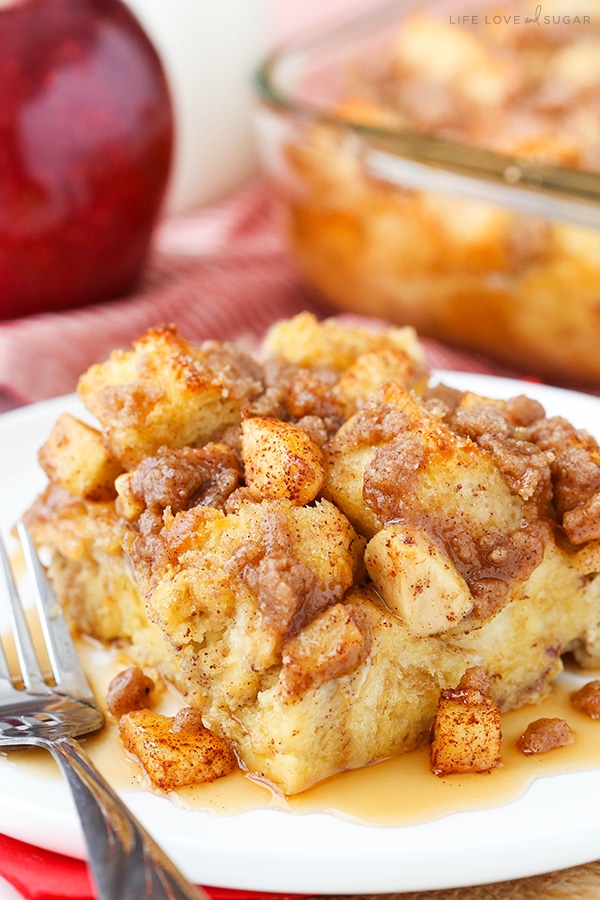 A serving of Overnight Cinnamon Apple French Toast on a white plate with a fork