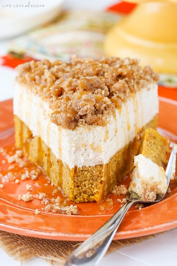 Caramel Pumpkin Spice Blondie Streusel Cheesecake slice on a plate with a bite on a fork