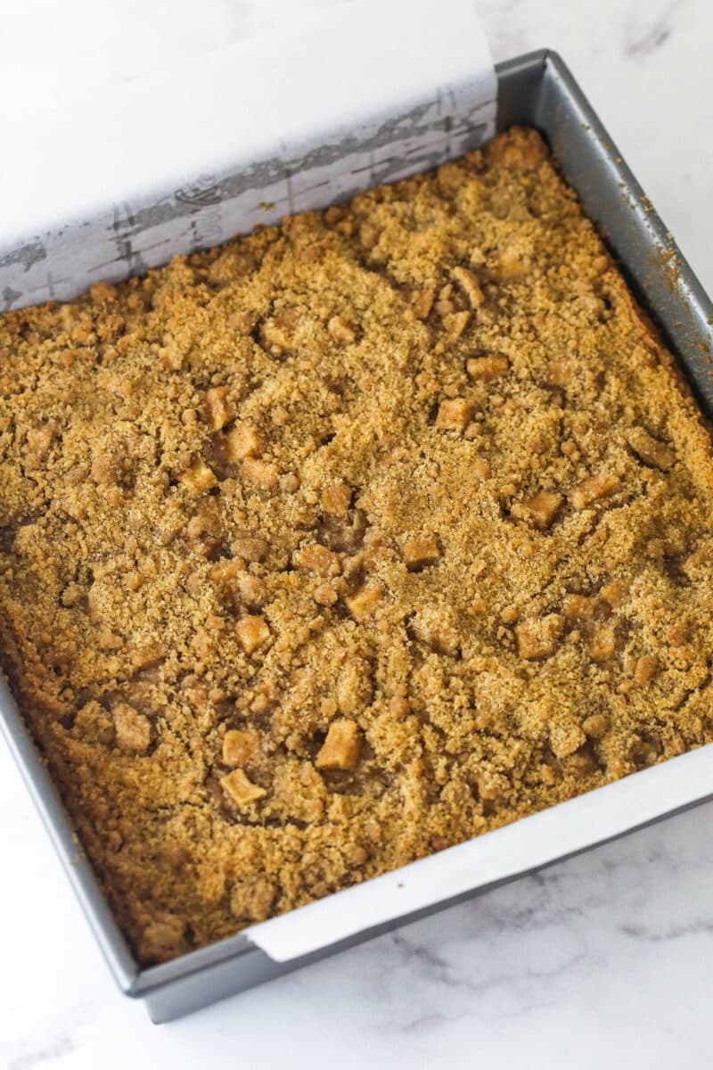 Every bite of these apple streusel bars is dotted with crunchy apples and warm fall flavors. Easy to make & perfect for breakfast or dessert! Overhead view of a pan of baked apple streusel bars