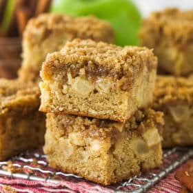 Apple streusel bars stacked on a wire rack