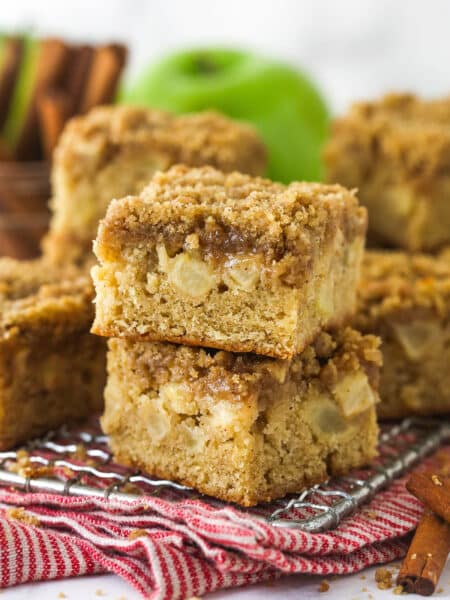 Apple streusel bars stacked on a wire rack