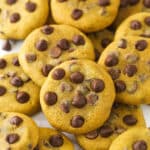 a scattered pile of pumpkin chocolate chip cookies on marble countertop