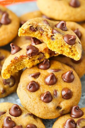 A Plate of Pumpkin Chocolate Chip Cookies with One Cookie Broken in Half on Top