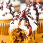 image of Pumpkin Chocolate Chip Cupcakes with Cream Cheese Frosting with bite taken out