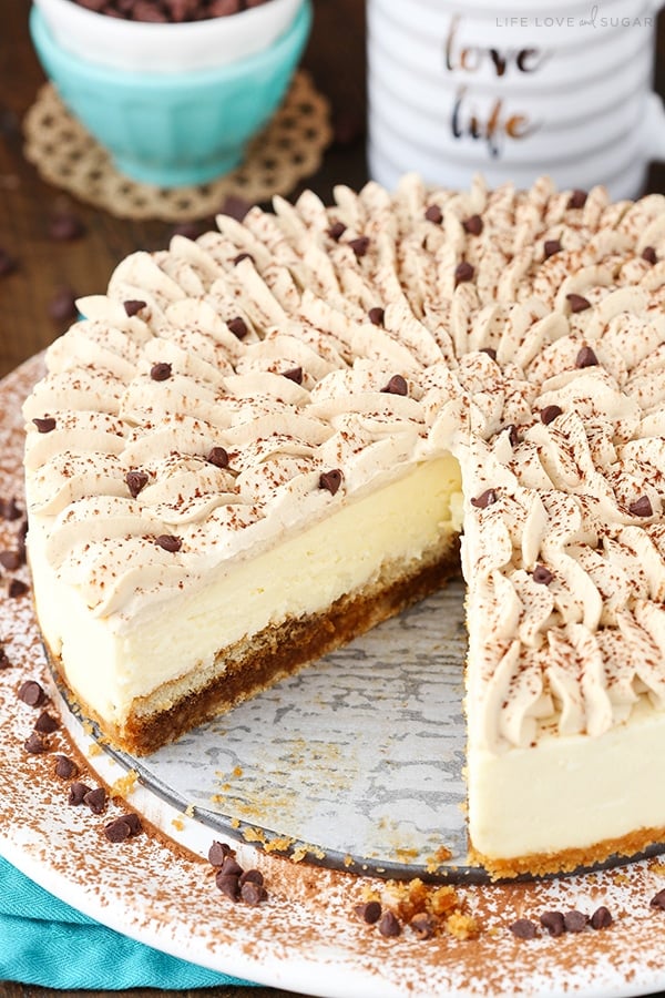 A tiramisu cheesecake with a slice taken out