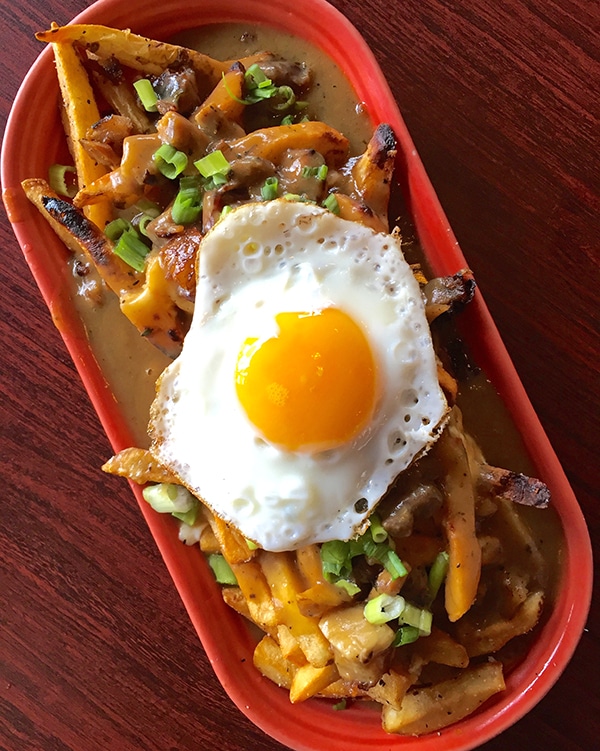 A Plate of Fries with Egg on Top