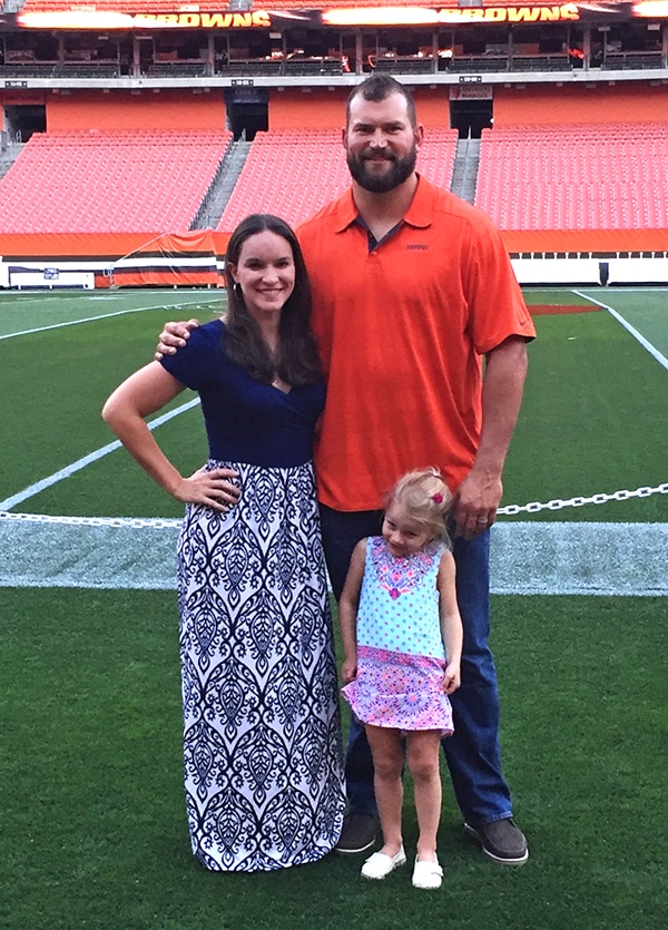 Lindsay Posing with Joe Thomas on the Football Field