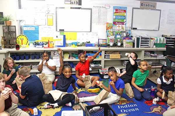 A Group of Schoolkids Sitting on a Classroom Carpet