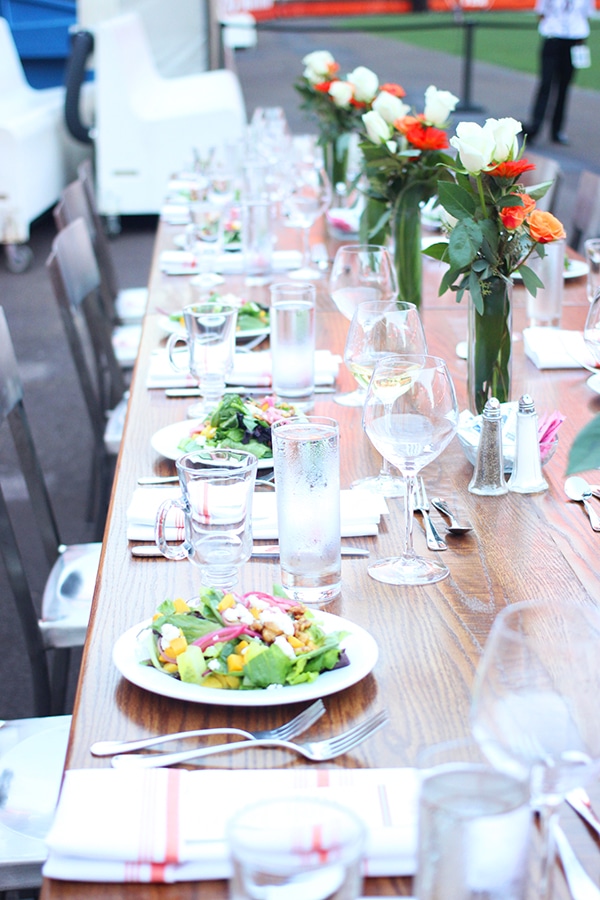 The Table Setup at the Football Game with a Salad on Every Plate