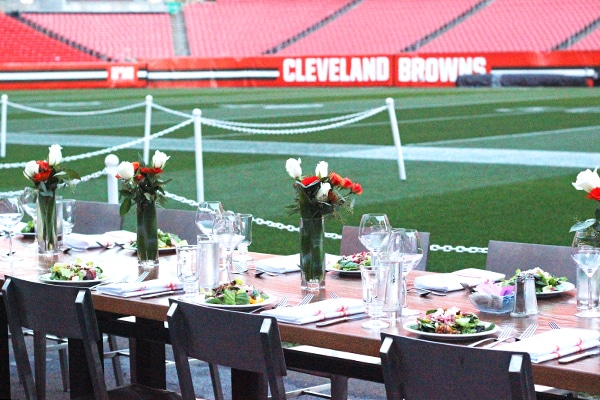 Our Tablescape at the Cleveland Browns Game with Vases of Red and White Flowers in the Center