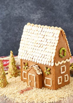 A homemade gingerbread house decorated with nuts.