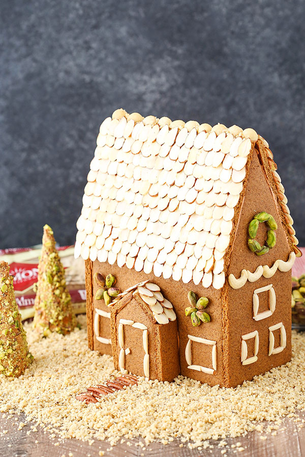 A homemade gingerbread house decorated with nuts