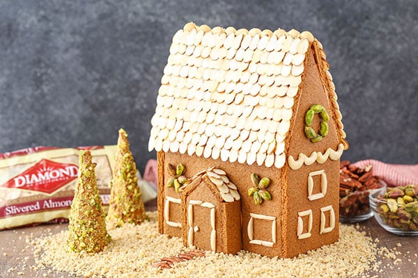 Homemade Gingerbread House surrounded by nuts