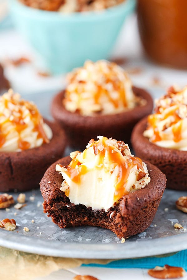 Turtle Chocolate Cookie Cups filled with caramel cheesecake and a sprinkle of pecans!