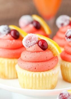 close up image of Cranberry Mimosa Cupcakes on cake stand