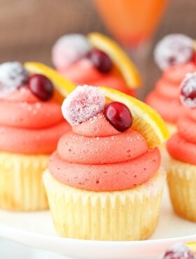 close up image of Cranberry Mimosa Cupcakes on cake stand