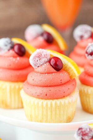 close up image of Cranberry Mimosa Cupcakes on cake stand
