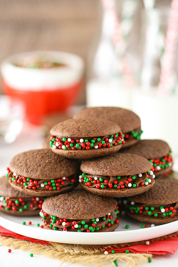 Chocolate cookies stuffed with chocolate and sprinkles on a white plate