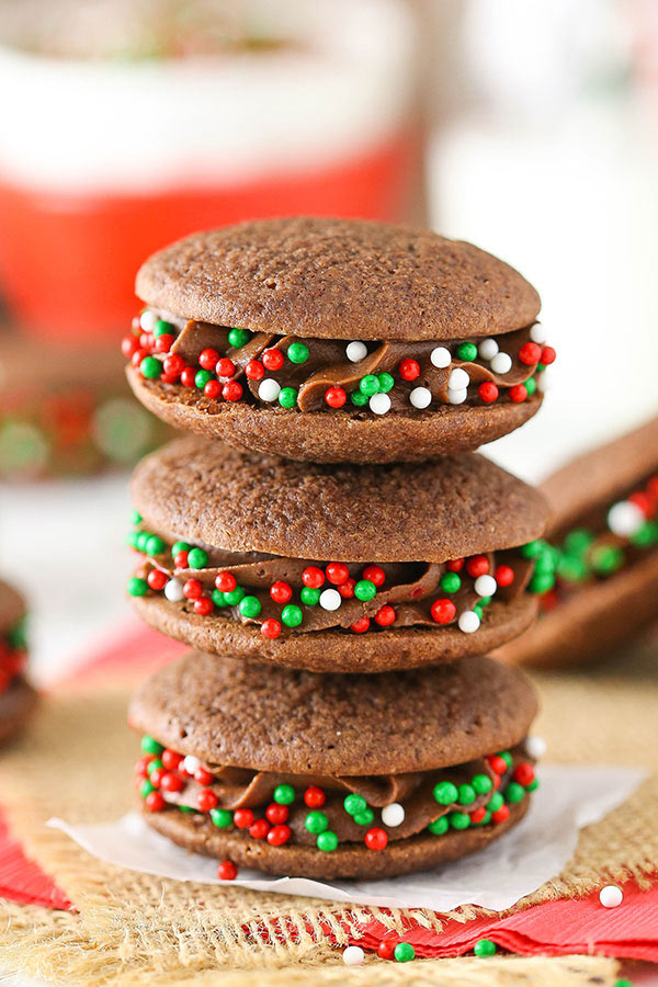 Three stacked chocolate filled cookies with holiday sprinkles 