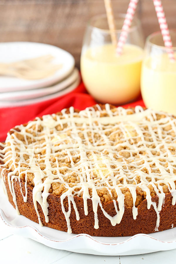 Finished eggnog coffee cake next to glasses of eggnog.