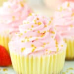 A close-up shot of a mini champagne cheesecake garnished with shiny gold star sprinkles