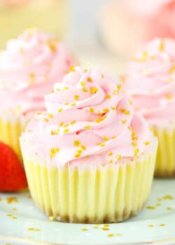 A close-up shot of a mini champagne cheesecake garnished with shiny gold star sprinkles