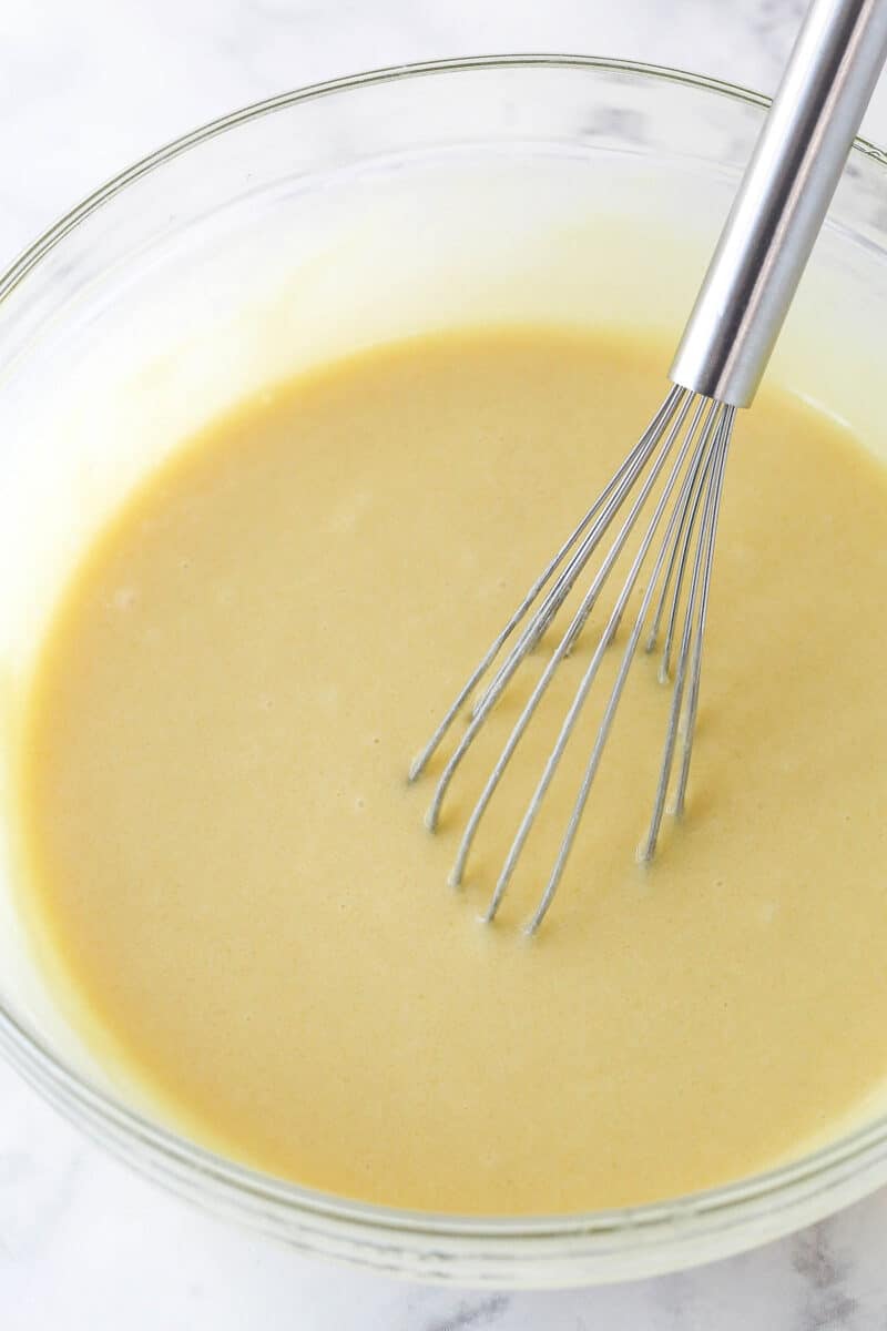 Whisking together the wet and dry cupcake ingredients.