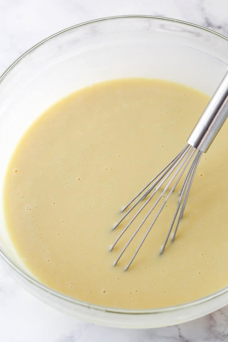 Whisking together vanilla cupcake batter.