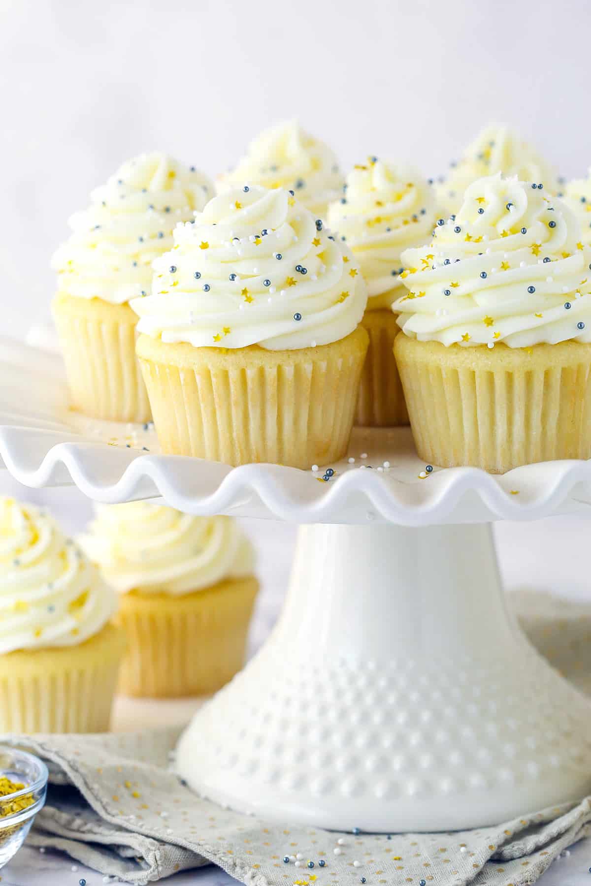 Moist vanilla cupcakes on a serving platter