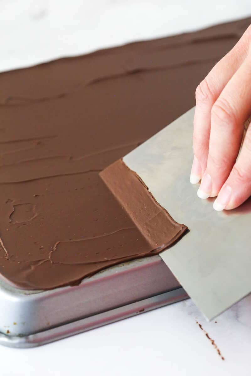 chocolate laying onto bench scraper, showing chocolate is too soft