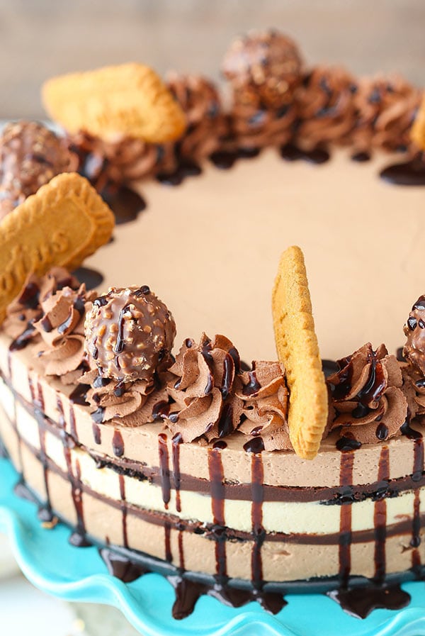 Close up of a Icebox Cake that is topped with Biscoff cookies, chocolate whipped cream and Ferrero Rocher