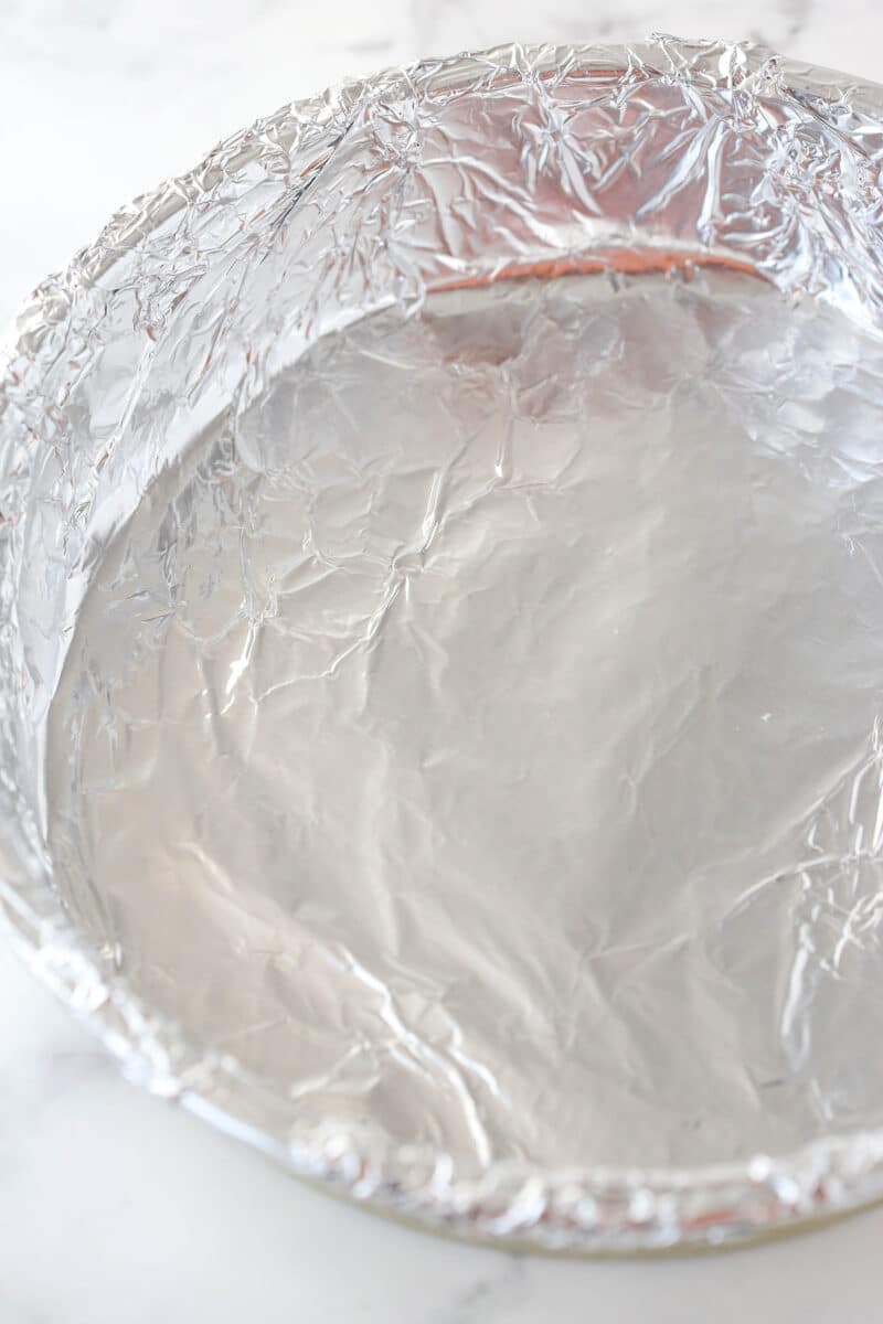 image of cake pan with aluminum foil pressed into it