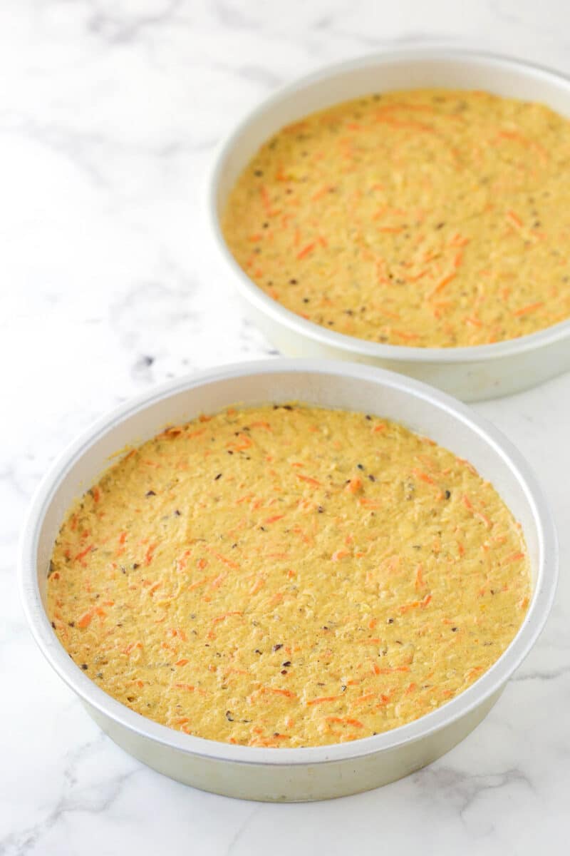 carrot cake batter in cake pans