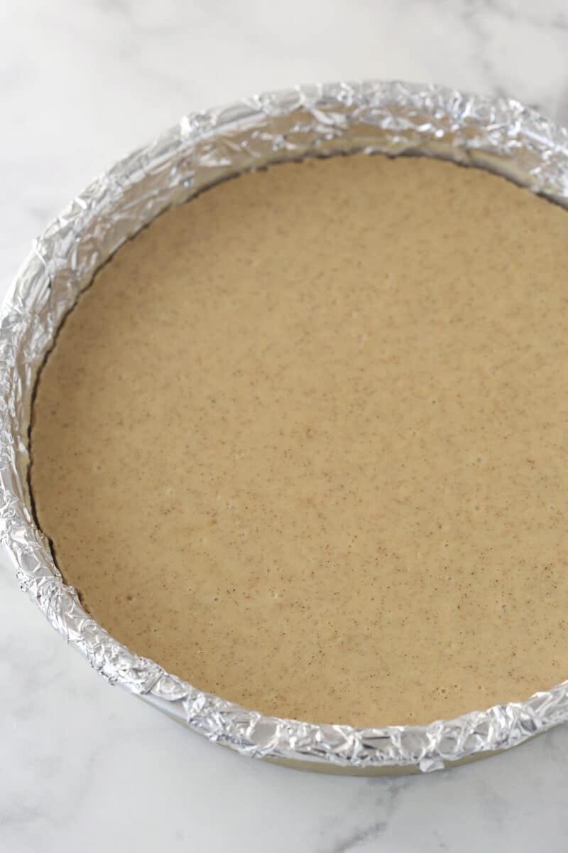 baked and cooled cheesecake layer in cake pan