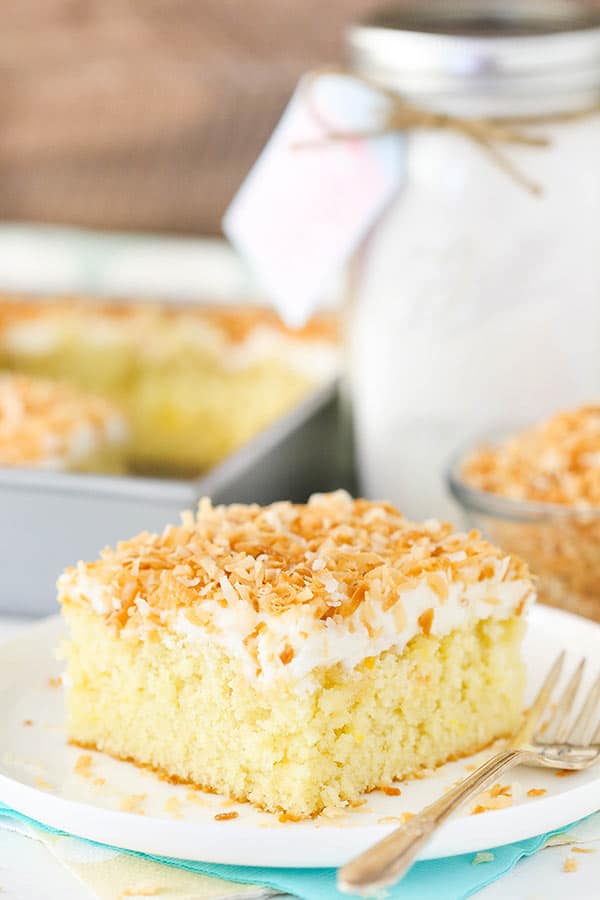 A Piece of Coconut Cake Topped with Frosting and Toasted Coconut