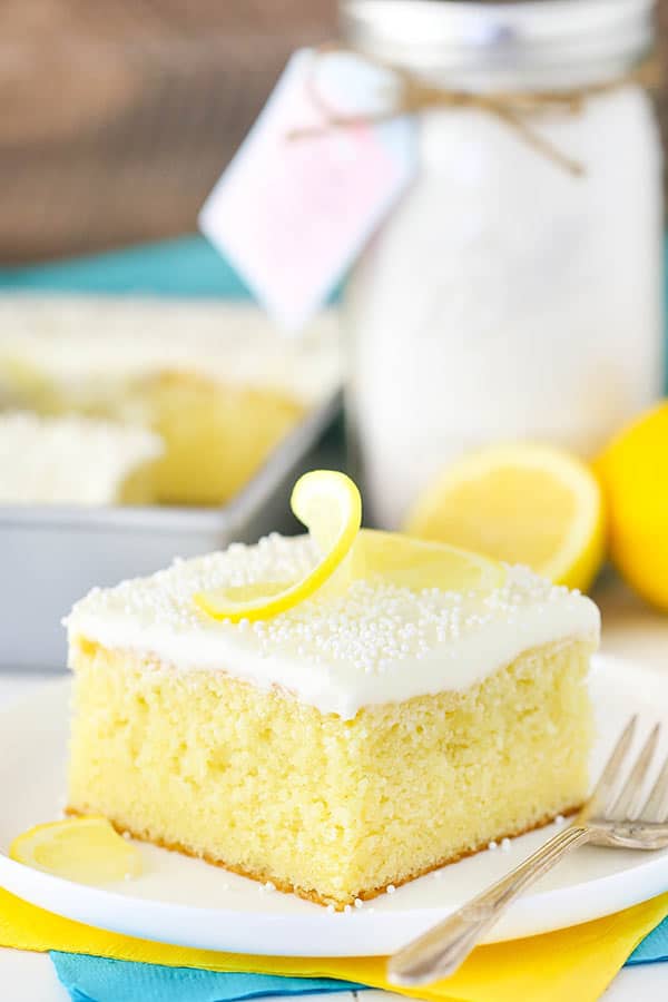 A Slice of Lemon Cake with Cream Cheese Frosting and a Lemon Garnish