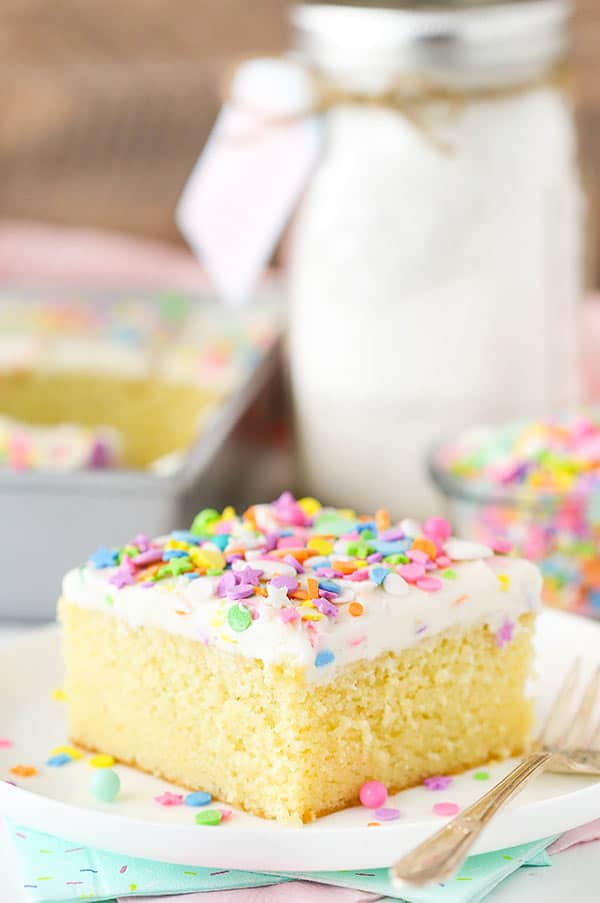 A Plate Holding a Slice of Vanilla Cake with Buttercream Frosting and Sprinkles