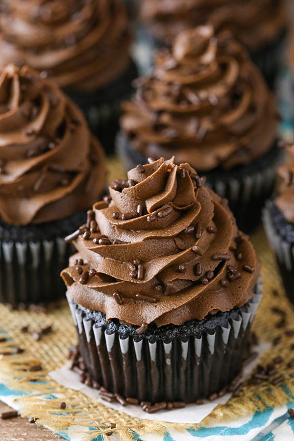 moist chocolate cupcakes sitting on burlap with sprinkles