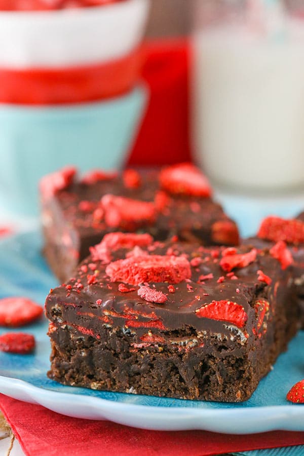 Two strawberry brownies on a blue plate.