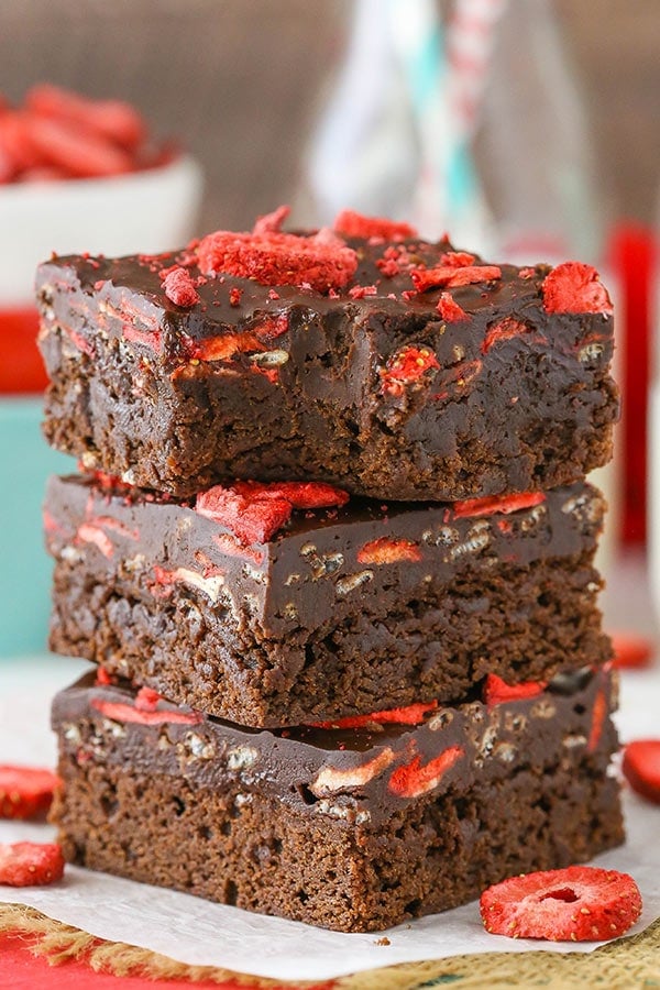 Stack of 3 Fudgy Strawberry Chocolate Brownies with a bite taken out of the top brownie.