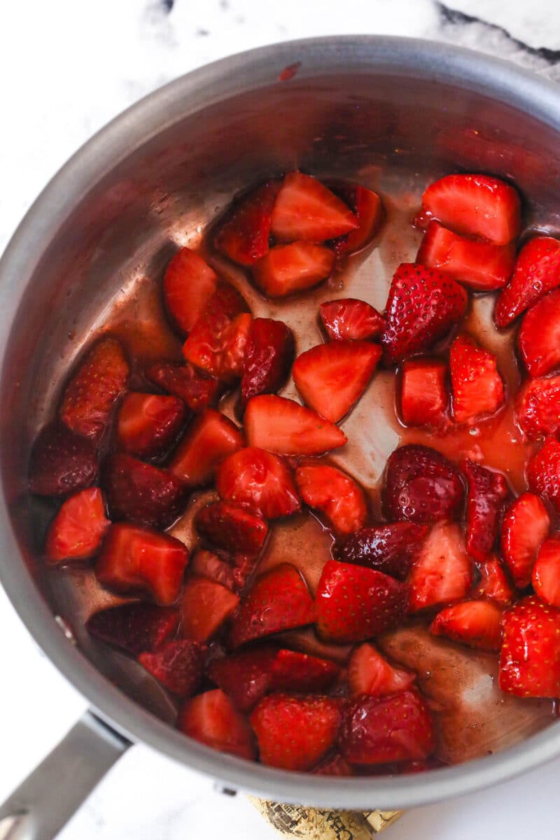 Strawberry sauce is swirled on top of moist, cakey brownies, adding a pop of color and fresh fruit flavor in these strawberry brownies. Chopped strawberries in a saucepan