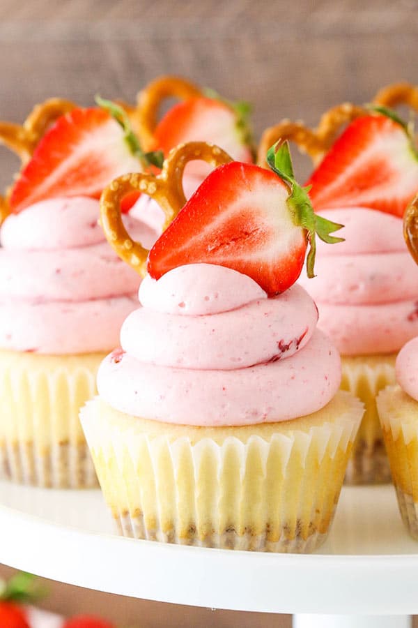 Strawberry Pretzel Salad Cupcakes - modeled after the classic dessert with a pretzel crust, cream filling and strawberry JELLO frosting!
