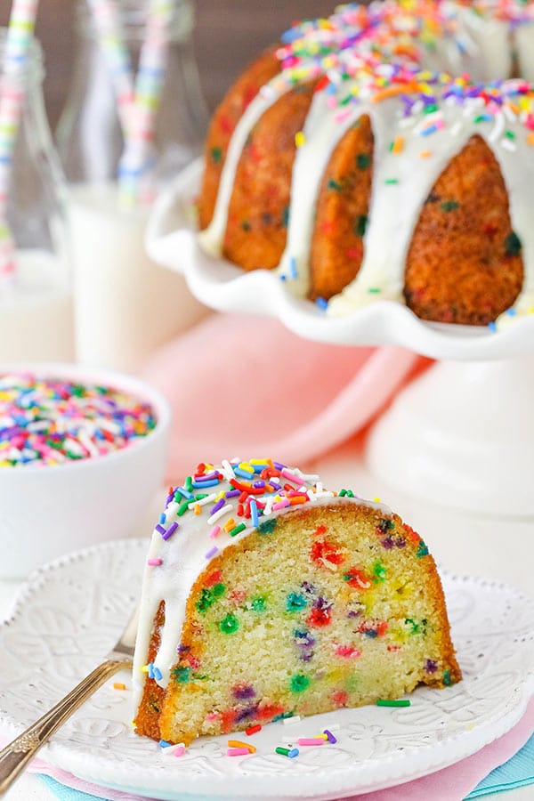 A big slice of Funfetti Cake on white plate