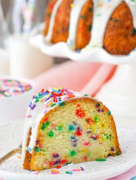 A big slice of Funfetti Cake on white plate