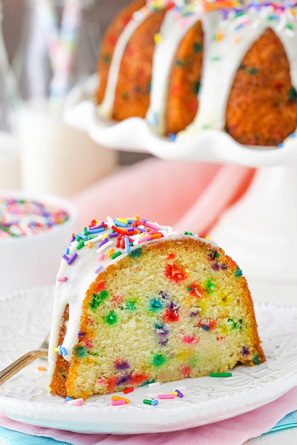 Side view of a slice of Funfetti Cake so the sprinkles inside are visible 