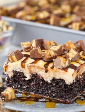 slice of Snickers Poke Cake