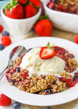 A scoop of triple berry crisp topped with vanilla ice cream.