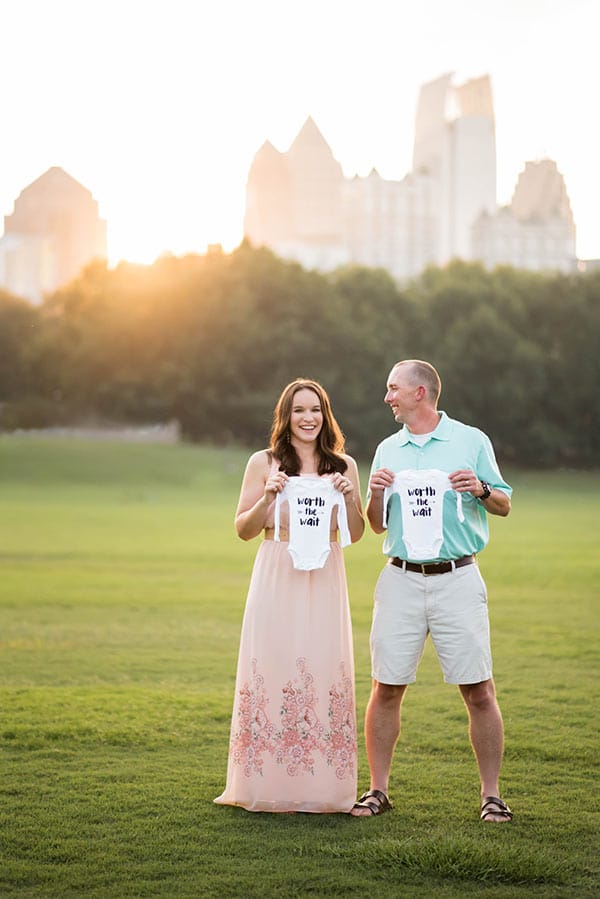 Lindsay and Ian holding shirts that say worth the wait