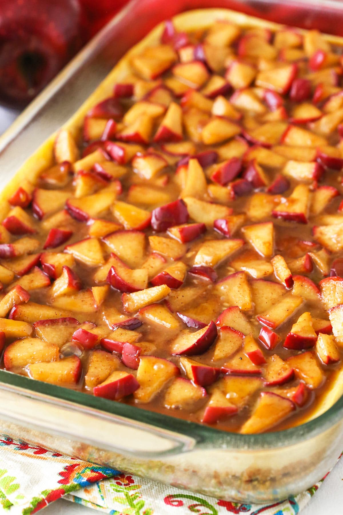 The crust, filling and topping for the bars layered into a glass baking dish