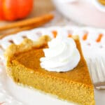 A slice of Classic Pumpkin Pie on plate.